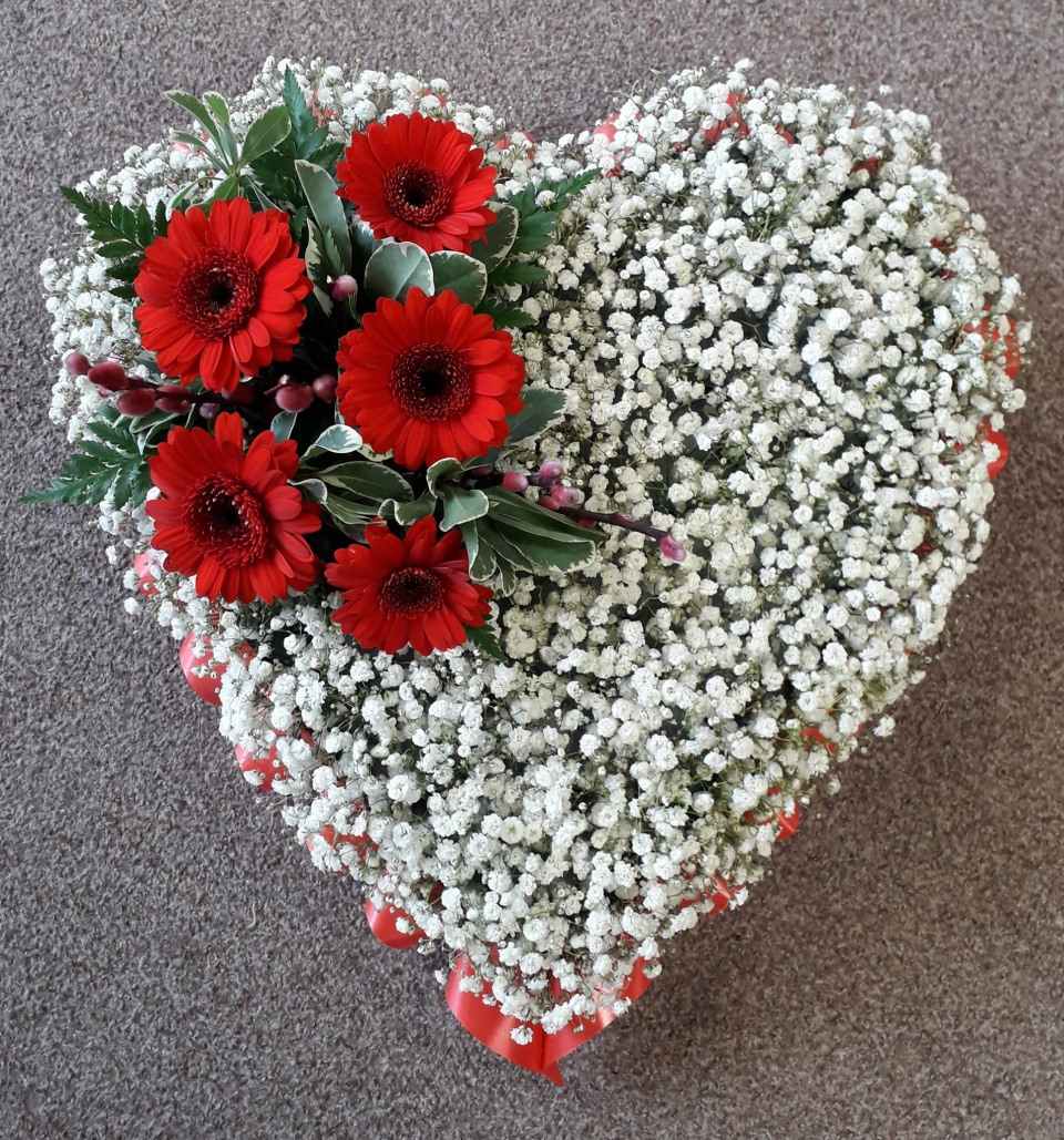 Fantasy Flowers heart bouquet with red flowers and small white ones.