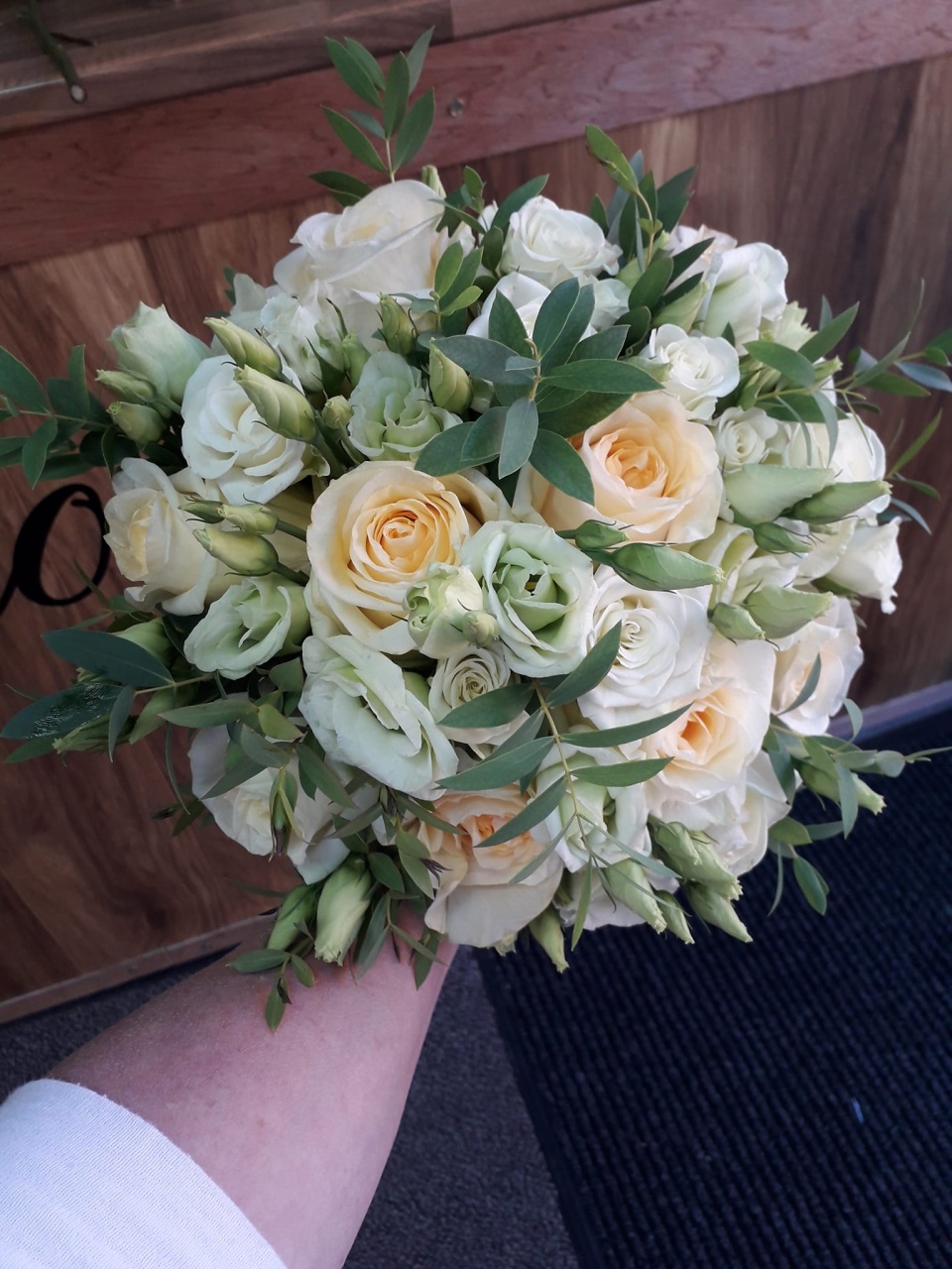 a wedding bouquet with yellow and white roses