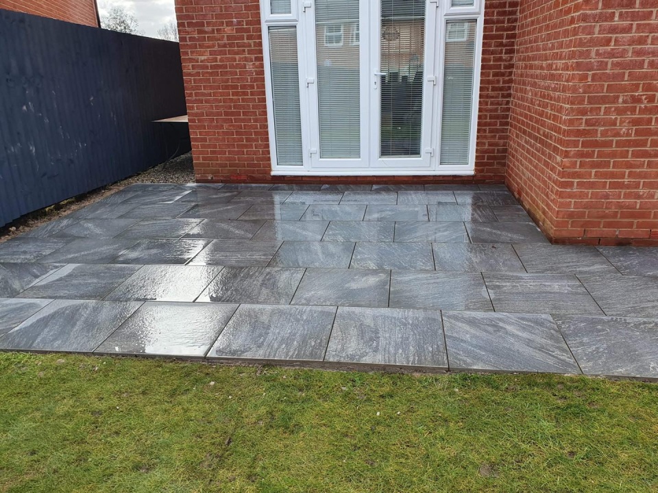 Image of slates in a backgarden and fake grass