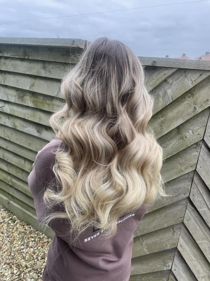 Root melt to platinum blonde hair style, curvy waves