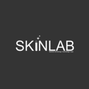 SkinLab logo. On a neutral dark grey-black background. Text is in centre and white. The I is shaped like a scientific flask, with bubbles above it.