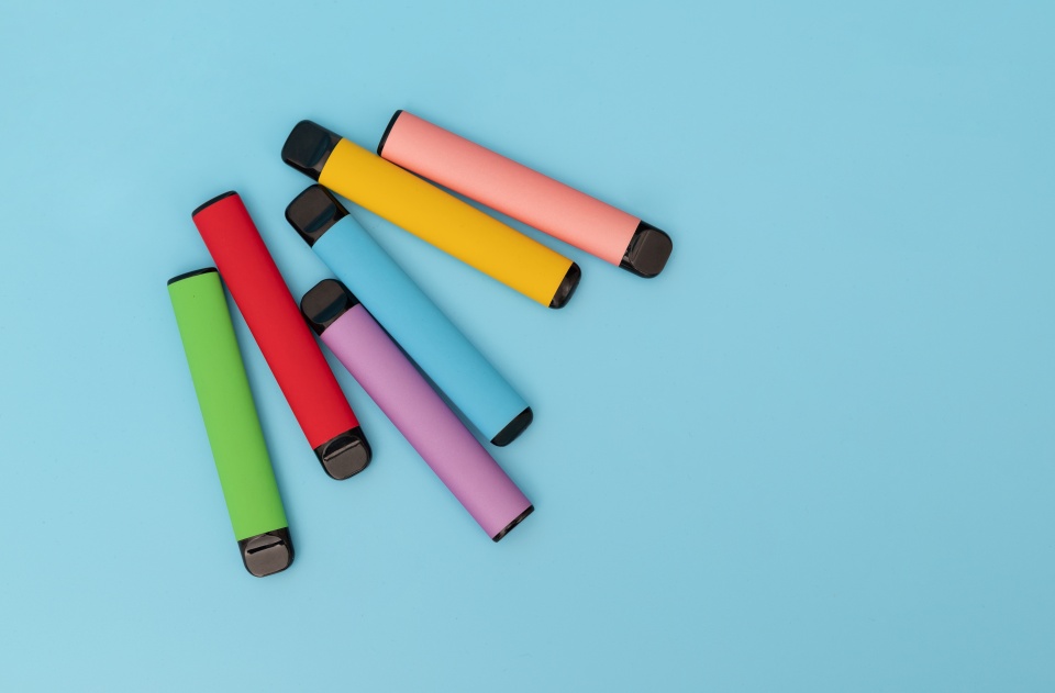 An image of colourful vapes on a blue background